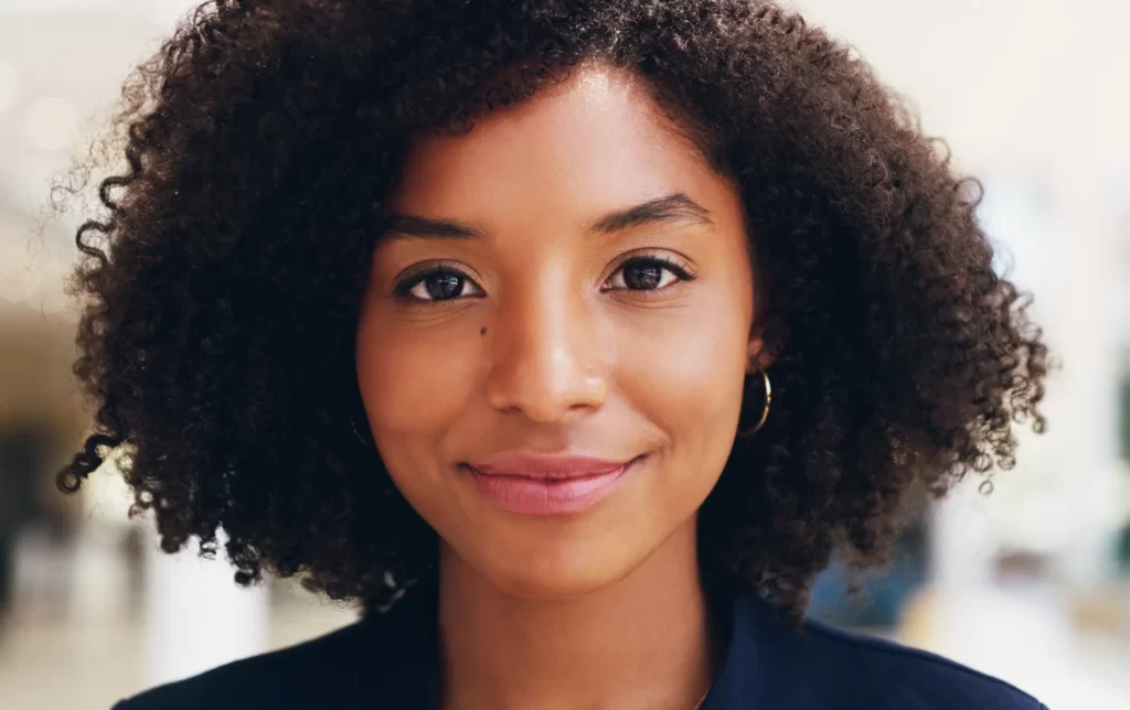confident woman smiling in a professional setting utc